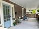 Inviting brick front porch with painted blue door and comfortable seating area at 300 W Thomas St, Salisbury, NC 28144