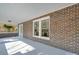 Beautiful brick front porch with classic columns and neutral colors, offering a relaxing outdoor space at 300 W Thomas St, Salisbury, NC 28144