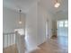 Hallway with hardwood floors, stairs, and natural light from multiple windows at 300 W Thomas St, Salisbury, NC 28144