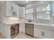 Bright kitchen features white cabinets, stainless steel appliances, and farmhouse sink at 300 W Thomas St, Salisbury, NC 28144