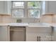 Bright kitchen features white cabinets, stainless steel appliances, and farmhouse sink at 300 W Thomas St, Salisbury, NC 28144