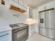 Modern kitchen featuring white cabinets, stainless appliances, and subway tile backsplash at 300 W Thomas St, Salisbury, NC 28144