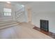 Light-filled living room with hardwood floors, decorative fireplace, and staircase, creating a cozy and inviting atmosphere at 300 W Thomas St, Salisbury, NC 28144