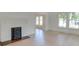 Bright living room with a decorative fireplace and light wood floors at 300 W Thomas St, Salisbury, NC 28144