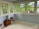 Cozy sunroom featuring large windows providing ample natural light and a view of the lush outdoors at 300 W Thomas St, Salisbury, NC 28144