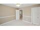 Modest bedroom with a view to the downstairs landing and cream colored walls at 3104 Highgate Dr, Fort Mill, SC 29715