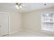 Neutral bedroom featuring a window, ceiling fan, and a closet door at 3104 Highgate Dr, Fort Mill, SC 29715