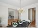 Elegant dining room with modern table, decorative ceiling, and doorway views into other rooms at 3104 Highgate Dr, Fort Mill, SC 29715