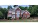 Charming two-story red brick home with manicured landscaping and a welcoming front porch at 3104 Highgate Dr, Fort Mill, SC 29715