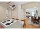 Bright kitchen featuring an island with cooktop and dining seating adjacent to living room at 3104 Highgate Dr, Fort Mill, SC 29715