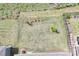 Aerial of level backyard features lawn, trees, and a fenced area at 329 Secretariat Dr, Iron Station, NC 28080