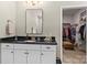 Bathroom featuring granite countertop, white cabinetry, and a walk-in closet at 329 Secretariat Dr, Iron Station, NC 28080