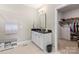 Bright bathroom with a double vanity, granite countertops, and a walk-in closet at 329 Secretariat Dr, Iron Station, NC 28080