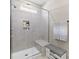 Modern bathroom featuring a tiled shower with a glass door and built-in shelving at 329 Secretariat Dr, Iron Station, NC 28080