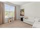 Cozy bedroom with a large window, comfortable seating, and neutral decor at 329 Secretariat Dr, Iron Station, NC 28080