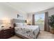 Comfortable bedroom with a floral comforter, side table, and a bright window at 329 Secretariat Dr, Iron Station, NC 28080