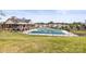 Spacious Community pool with a covered winter tarp, set in a green lawn with surrounding neighborhood at 329 Secretariat Dr, Iron Station, NC 28080