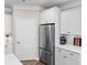 Kitchen detail with stainless steel refrigerator and white cabinets at 329 Secretariat Dr, Iron Station, NC 28080