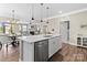 Open kitchen layout with island and view to dining and living areas at 329 Secretariat Dr, Iron Station, NC 28080