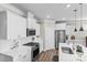 Bright white kitchen featuring stainless steel appliances and a modern island with a sink at 329 Secretariat Dr, Iron Station, NC 28080