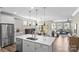 Open-concept kitchen with stainless steel appliances, island, and seamless flow to living spaces at 329 Secretariat Dr, Iron Station, NC 28080