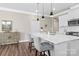 Modern kitchen island with a sink, seating, and stylish pendant lighting at 329 Secretariat Dr, Iron Station, NC 28080