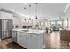 Modern kitchen with stainless steel appliances, a center island, and an open floor plan at 329 Secretariat Dr, Iron Station, NC 28080