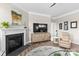 Cozy living room with a fireplace, decorative console, and neutral decor at 329 Secretariat Dr, Iron Station, NC 28080