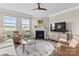 Bright living room with a fireplace, plush seating, and large windows at 329 Secretariat Dr, Iron Station, NC 28080