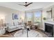 Comfortable living room with fireplace, bright windows, and a modern ceiling fan at 329 Secretariat Dr, Iron Station, NC 28080