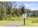Scenic walking trail entrance with lush greenery, trees, and a clear path for outdoor enjoyment at 329 Secretariat Dr, Iron Station, NC 28080