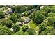 Aerial view showcases two houses, manicured lawn, and surrounding mature trees at 3712 Eaglebrook Dr, Gastonia, NC 28056