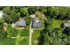Aerial view of property with multiple structures, long driveway and surrounding mature trees at 3712 Eaglebrook Dr, Gastonia, NC 28056