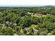 Aerial view shows a property close to a golf course and lush landscape with mature trees at 3712 Eaglebrook Dr, Gastonia, NC 28056