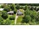 Aerial view of property featuring two houses, long driveway, and lush green landscaping at 3712 Eaglebrook Dr, Gastonia, NC 28056