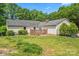 Exterior of the home from backyard, featuring a brick patio and a lush green lawn at 3712 Eaglebrook Dr, Gastonia, NC 28056