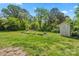 Large backyard with a lush green lawn and a storage shed at 3712 Eaglebrook Dr, Gastonia, NC 28056