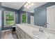 Bathroom features a double sink vanity, large mirror, natural light from the window, and wood-look floors at 3712 Eaglebrook Dr, Gastonia, NC 28056