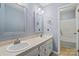 Bright bathroom featuring a double sink vanity, modern fixtures, and a doorway leading to the tub and shower at 3712 Eaglebrook Dr, Gastonia, NC 28056
