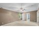Spacious bedroom featuring neutral carpet, tan walls, and a ceiling fan at 3712 Eaglebrook Dr, Gastonia, NC 28056