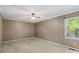 Spacious bedroom featuring neutral carpet, tan walls, and a ceiling fan at 3712 Eaglebrook Dr, Gastonia, NC 28056