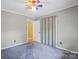 Bedroom with carpeted floor, an open doorway and grey walls at 3712 Eaglebrook Dr, Gastonia, NC 28056