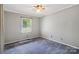 This bedroom has neutral carpet and light gray walls plus a ceiling fan at 3712 Eaglebrook Dr, Gastonia, NC 28056