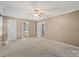 Primary bedroom featuring neutral carpet, tan walls, and a ceiling fan at 3712 Eaglebrook Dr, Gastonia, NC 28056