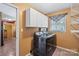 Bright laundry room with window, upper cabinets, washer, and dryer at 3712 Eaglebrook Dr, Gastonia, NC 28056