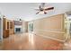 Open-concept room featuring a fireplace, wood floors, natural light, built in bookcase, and decorative wall panels at 3712 Eaglebrook Dr, Gastonia, NC 28056