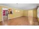 Spacious room featuring wood floors, neutral walls, with an adjoined kitchen, and well-lit with natural light at 3712 Eaglebrook Dr, Gastonia, NC 28056