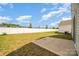 Spacious backyard features a well-maintained lawn and a concrete patio, perfect for outdoor activities at 4009 Stoneygreen Ln, Charlotte, NC 28215