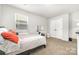 Inviting bedroom includes a large window, comfortable bed, and a functional vanity area at 4009 Stoneygreen Ln, Charlotte, NC 28215