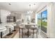 Dining room with hardwood floors, modern light fixture, and view of the backyard at 4009 Stoneygreen Ln, Charlotte, NC 28215
